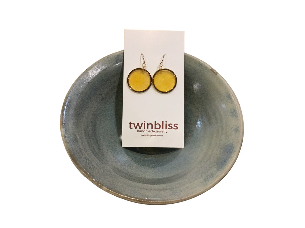 Gold hoops in yellow earrings