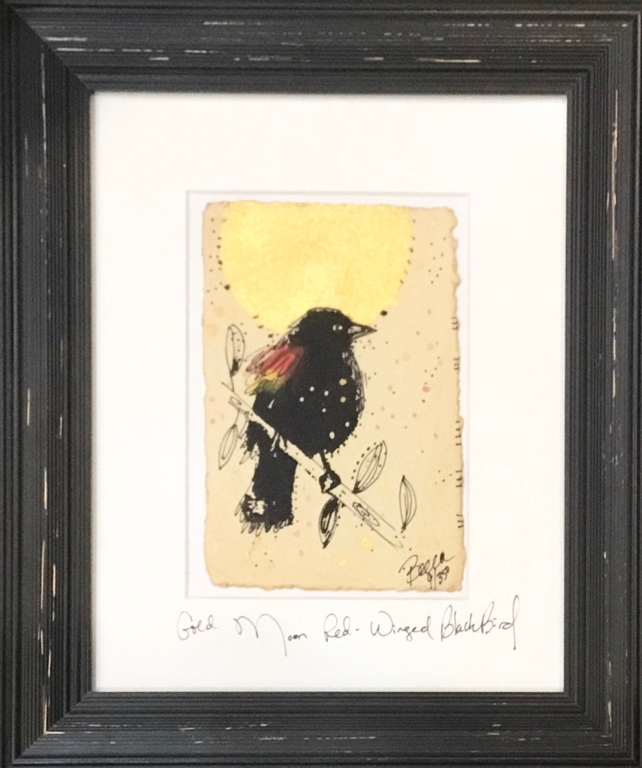 Red winged black bird gold moon