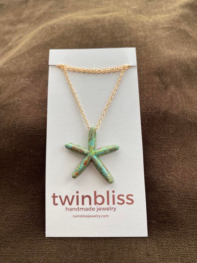 Sedona patina starfish on gold necklace