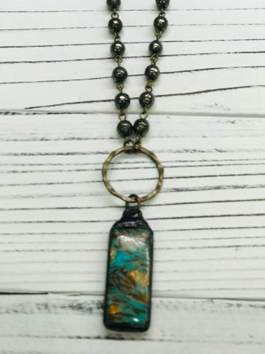 Oblong copper pendant